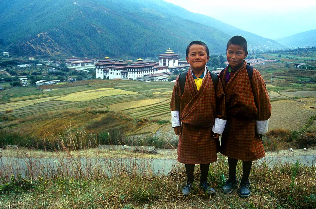 Smiling children & Royal Palace, Thimphu, Bhutan